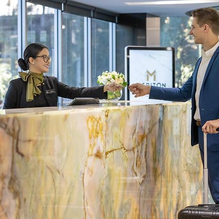 Meriton Suites North Ryde Sydney Exterior photo A hotel receptionist
