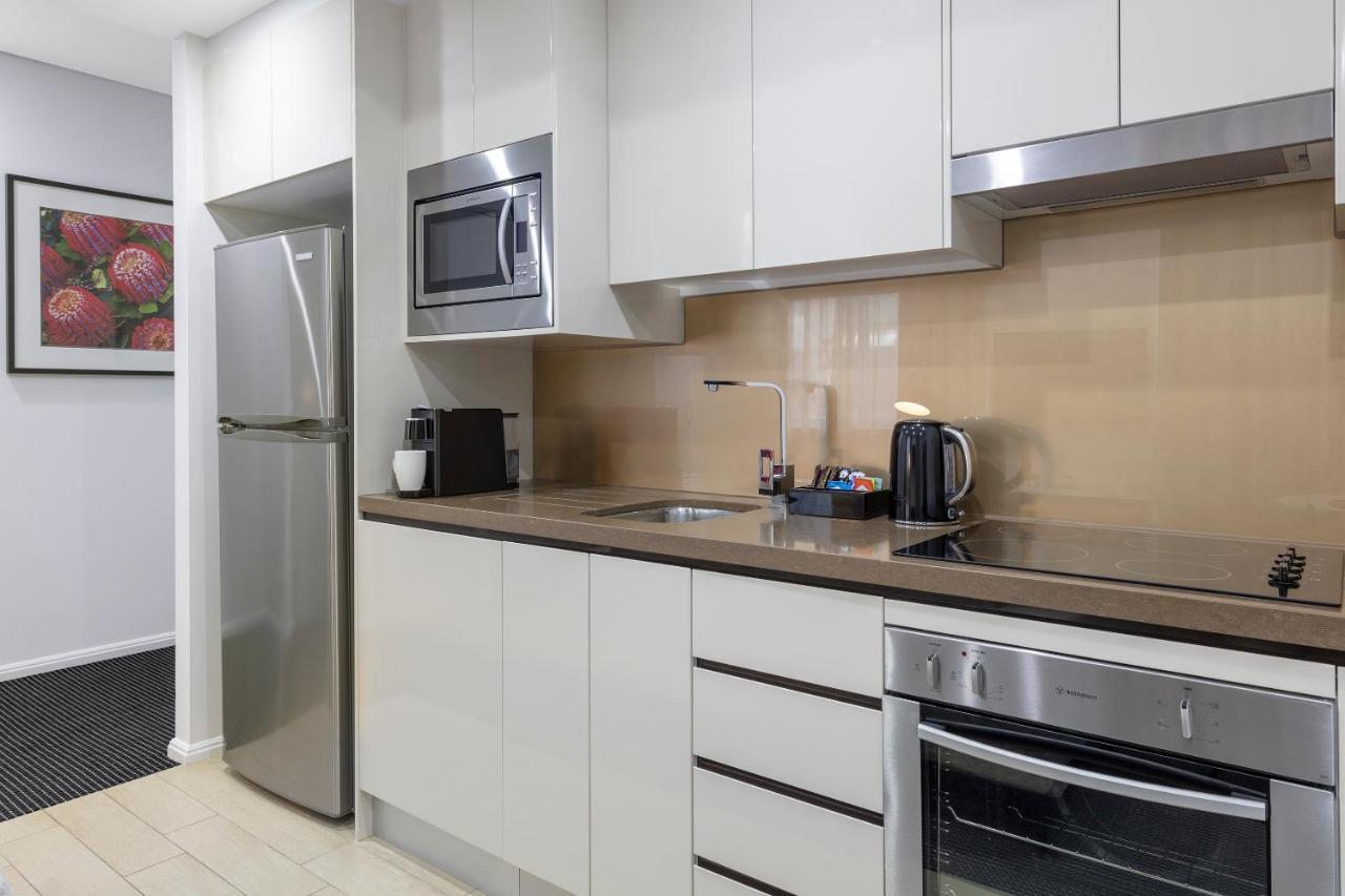 Meriton Suites North Ryde Sydney Exterior photo A typical kitchen in a serviced apartment