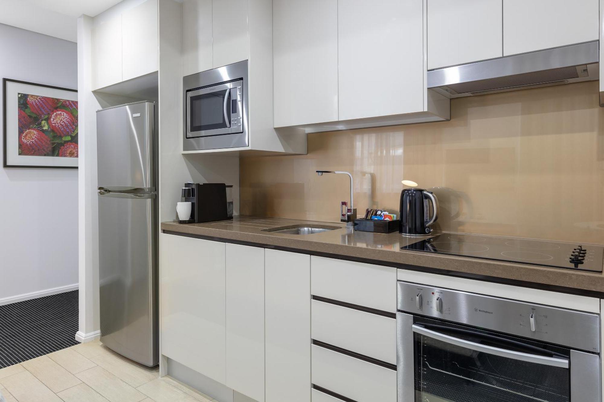 Meriton Suites North Ryde Sydney Exterior photo A typical kitchen in a serviced apartment